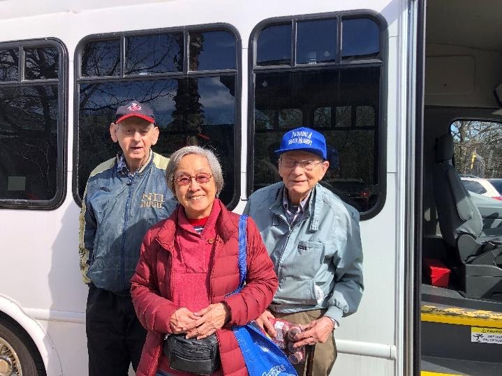 van with three seniors standing in front